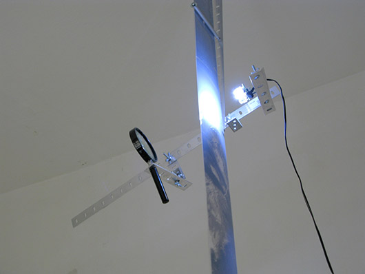 A Single Composite [rect] (2011), Acetate film, aluminum, glass, motors, electronics, satellite photographs