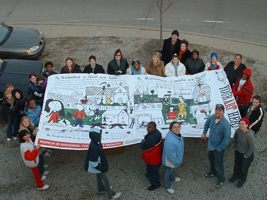 Billboard Generation II, 2004. The second Youth Art billboard competition took place in Bloomington and Indianapolis, resulting in four billboards in each city. Eight different artworks made by students in grades k-12 responded to the question "What would you like to tell your community?" Winning themes included the effects of pollution on our environment, diversity, and the importance of community involvement. Members of Your Art Here hanging "My Neighborhood Is, Billboard Generation II, Indianapolis, IN, 2004" with winnners from the Minnie Hartman School, Indianapolis thumbnail-3
